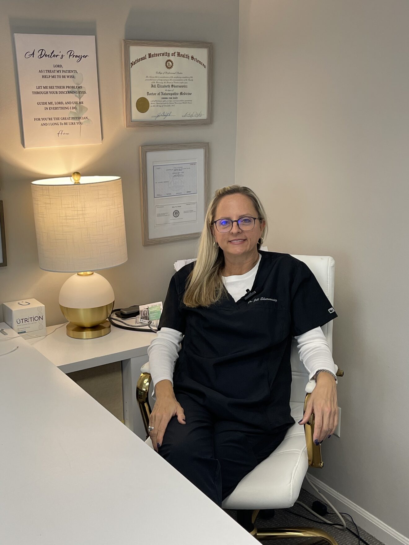 Dr. Jill Skurnowicz, ND, CRNA at her desk at Natural Care Institute