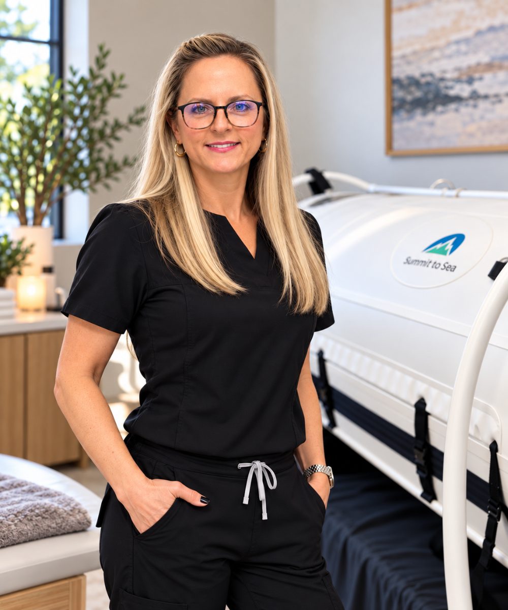 Dr. Jill Skurnowicz beside the mild hyperbaric oxygen chamber at Natural Care Institute